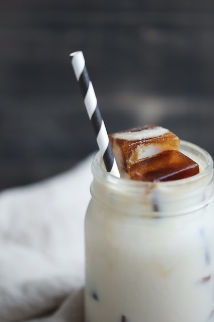 Free photo ice coffee with striped straw