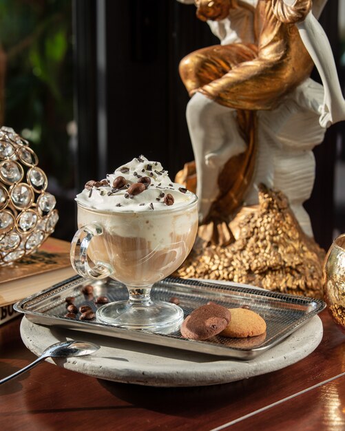 Ice coffee with whipped cream and cookies