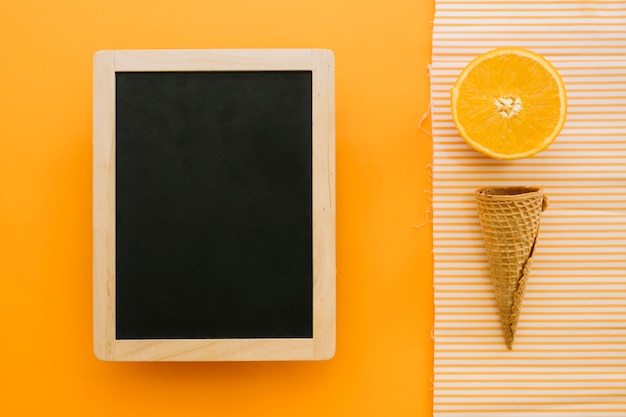 Ice cream concept with slate and orange slice