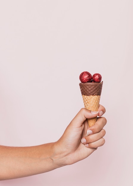 Free photo ice cream cone with blue disco balls at new years