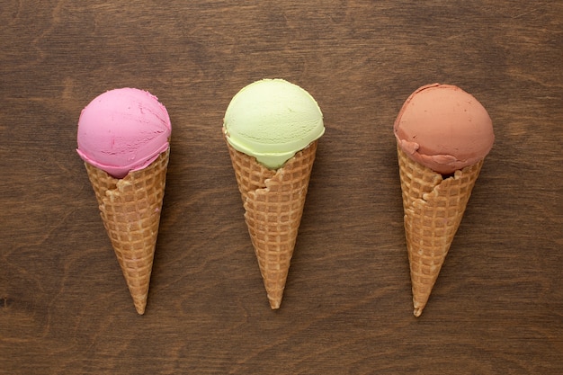 Ice cream on cones with flavour on table