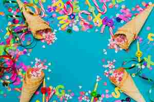 Free photo ice cream cones with hearts and confetti on a blue background