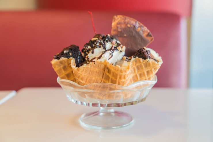 Free Photo ice cream sundae in an edible waffle bowl