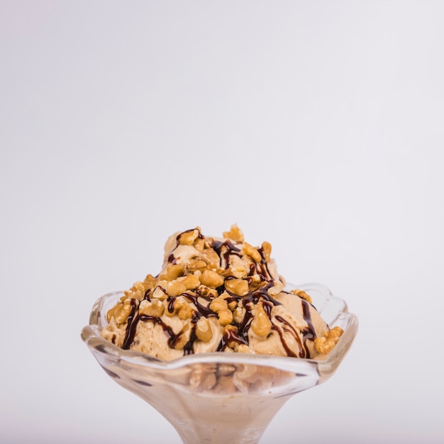 Ice cream with nuts in glass bowl
