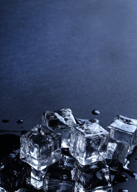 Ice cubes on black surface with copyspace