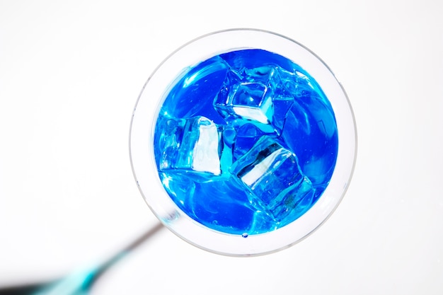 흰색 배경에 고립 된 블루 칵테일 마티니 잔에 얼음 조각