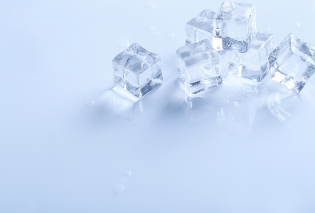 Ice cubes on white surface with copyspace