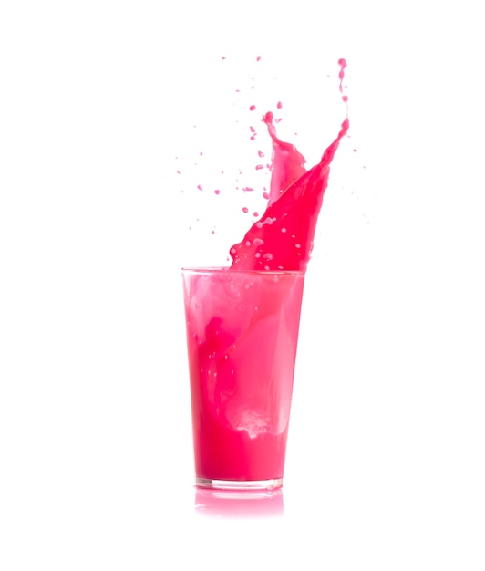 Ice falling in a glass with pink drink