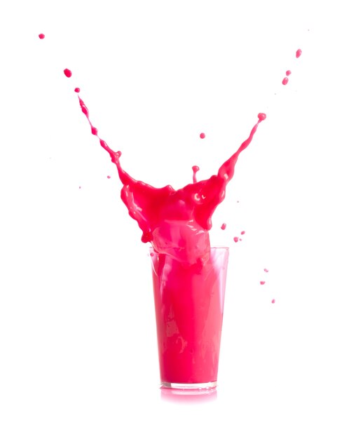 Ice falling in a glass with pink drink