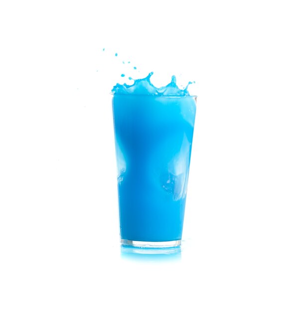 Ice falling into a glass with blue drink