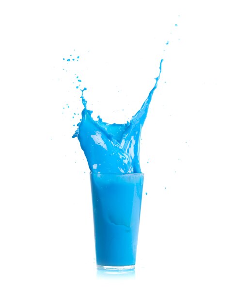 Ice falling into a glass with blue drink