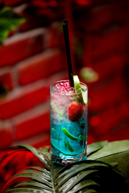 Free photo iced blue lagune cocktail with fruits