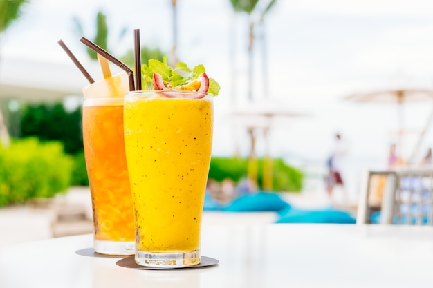 Iced cocktails drinking glass with beach and sea