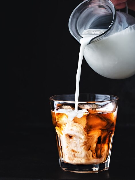 Iced coffee in a glass with ice and sugar syrup