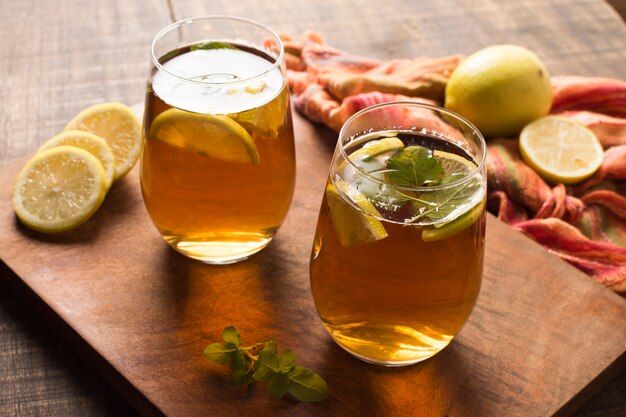 Iced lemon slices and mint leaves herbal tea on chopping board