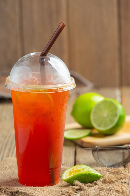 Iced Lemon Tea Glass with Honey Lemon On a wooden wall.