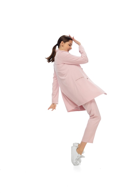 Free photo icon. happy young woman dancing in casual clothes or suit, remaking legendary moves and dances of celebrity from culture history. isolated on white. action, motion, fame concept. creative occupation.