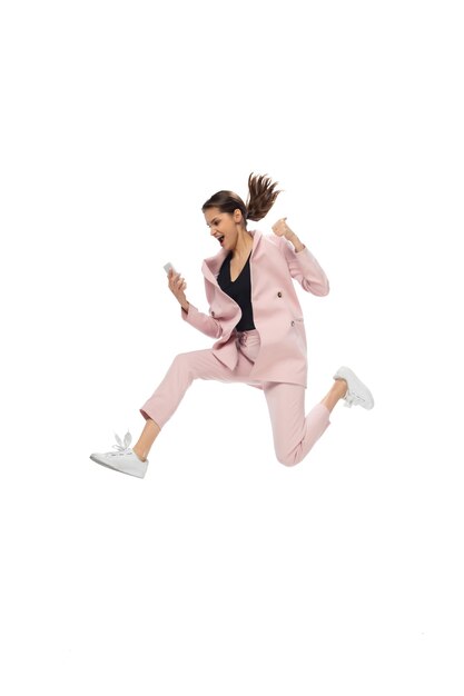 Icon. Happy young woman dancing in casual clothes or suit, remaking legendary moves and dances of celebrity from culture history. Isolated on white. Action, motion, fame concept. Creative occupation.