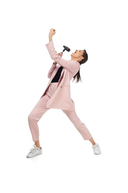 Icon. Happy young woman dancing in casual clothes or suit, remaking legendary moves and dances of celebrity from culture history. Isolated on white. Action, motion, fame concept. Creative occupation.