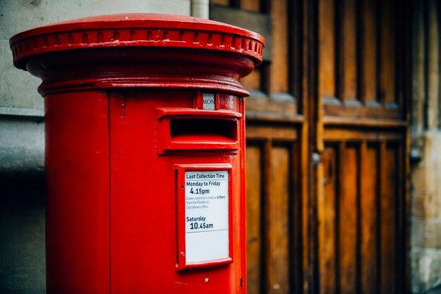 Iconic red British mailbox in a city