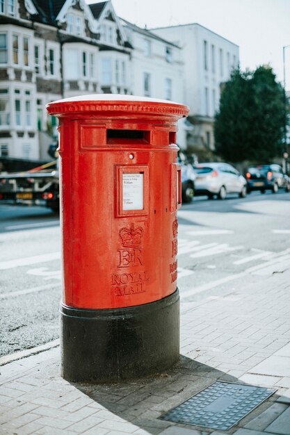 Iconic red British mailbox in a city