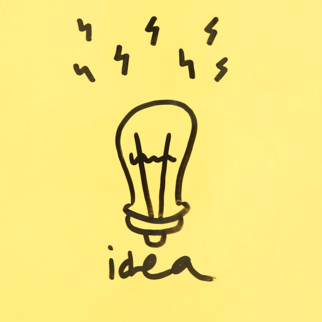 Idea concept with hand drawn light bulb on yellow background