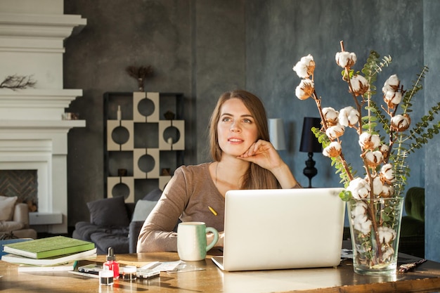 Idea concept. young woman working with new startup project in modern loft office. smiling girl with laptop