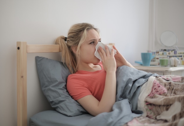 An ill female lying on bed