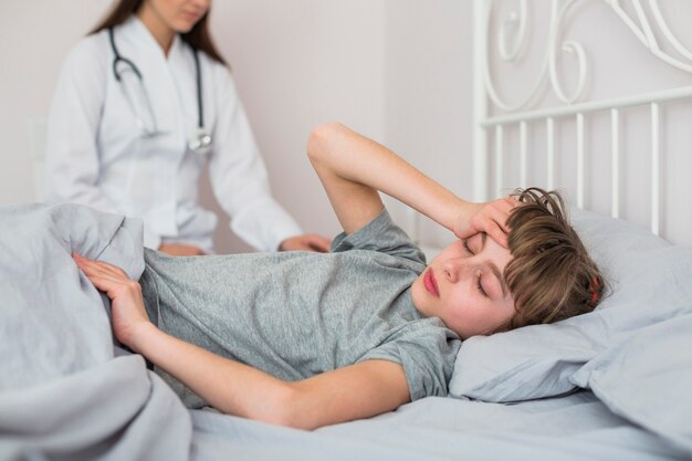 Ill girl being examined by the doctor