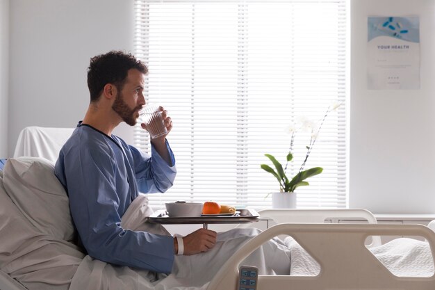 Ill male patient in bed at the hospital