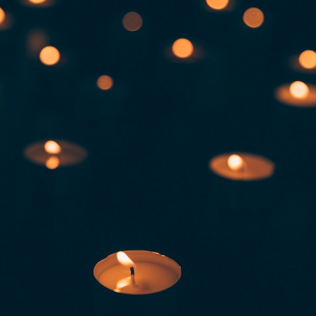 Illuminated candlelight on dark backdrop