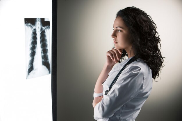 Image of attractive woman doctor looking at x-ray results