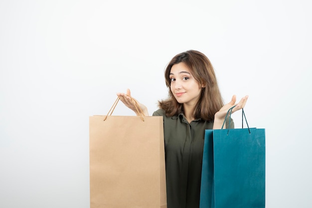 Free photo image of beautiful short-haired girl holding shopping bags. high quality photo