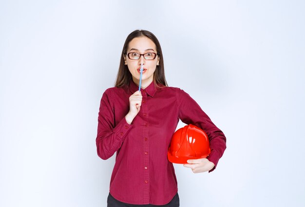 Image of beautiful woman in glasses holding crash helmet. 