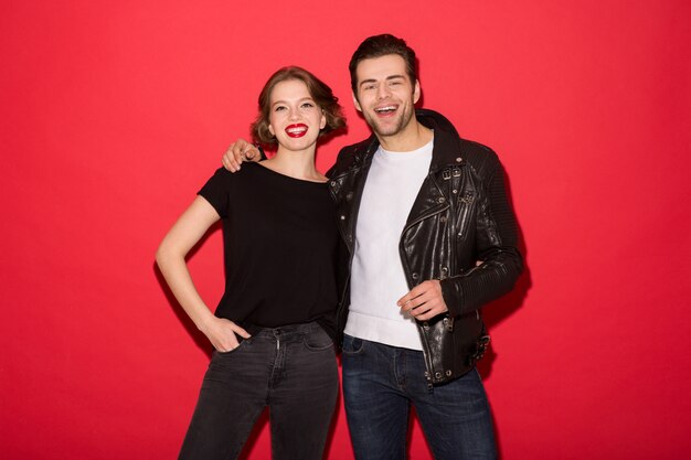 Image of Cheerful punk couple hugging and looking