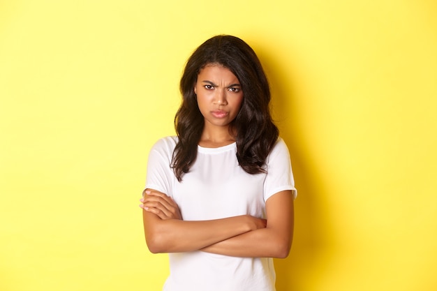 Image of cute africanamerican girl feeling angry cross arms on chest and frowning mad