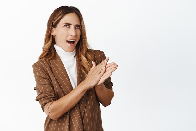 Image of determined businesswoman rub her hands and thinking having interesting idea with profit pondering money investments white background