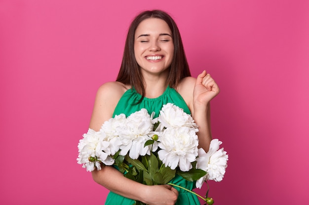 Image of good looking positive model posing isolated over pink