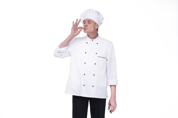 Image of handsome senior man chef indoors isolated over white wall