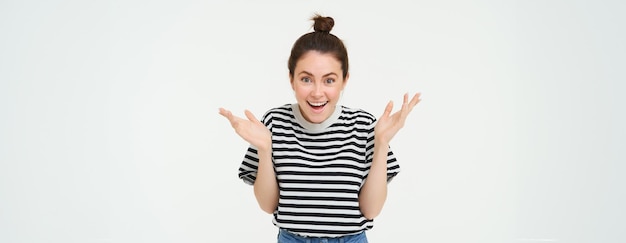 Free photo image of happy woman hear great news looking surprised claps hands and smiling isolated against