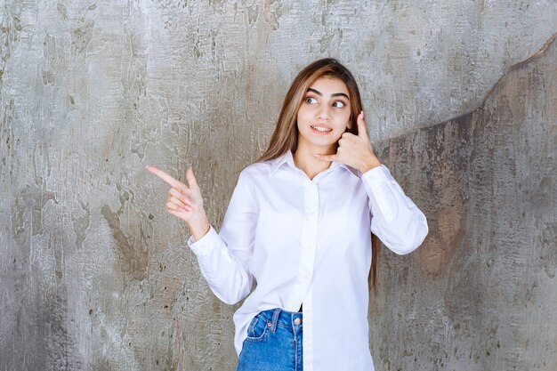 Image of long-haired young girl standing and doing some signs