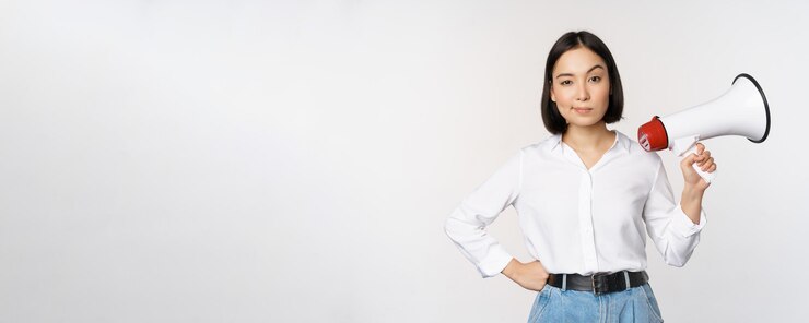 Free Photo image of modern asian woman with megaphone making announcement white background