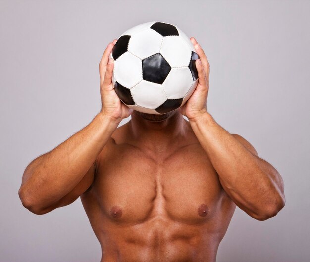 Image of muscle man posing with ball
