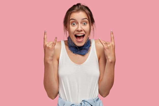 Free photo image of positive female rocker gestures indoor