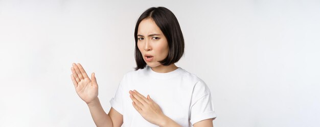 Image of sassy young asian woman standing in karate fighting pose martial arts fighter standing over white background