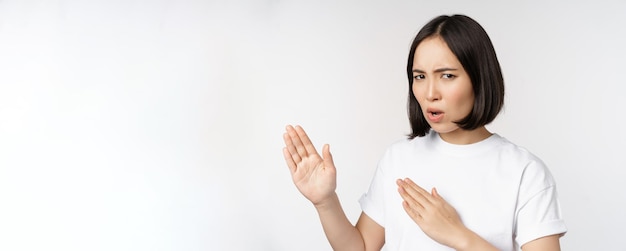 Image of sassy young asian woman standing in karate fighting pose martial arts fighter standing over white background