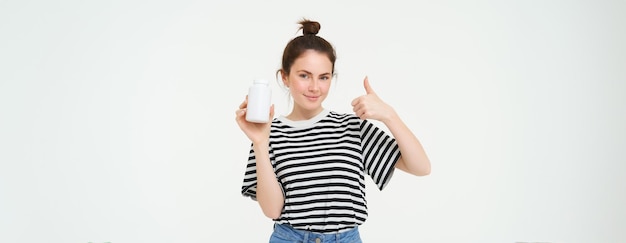 Image of smiling girl recommends dietary supplement bottle with vitamin c fish oil treatment stands