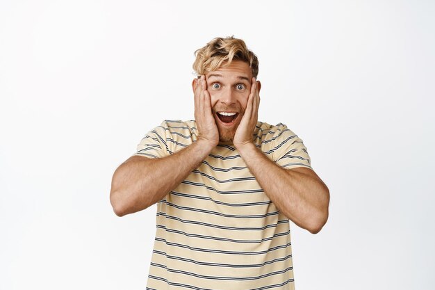 Image of super happy adult man reacting ot positive news smiling and laughing looking with enthusiastic disbelief white background