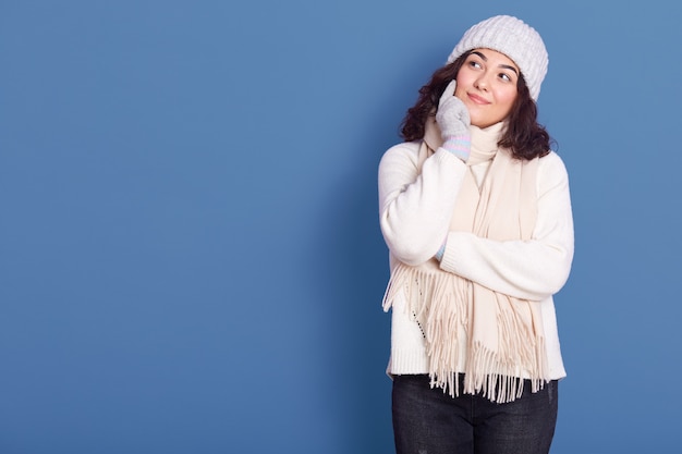 Image of thoughtful pensive cute young woman standing isolated over