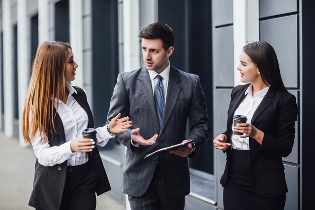 Image three business partners in black elegant suit talking and working together while discussing new strategy !